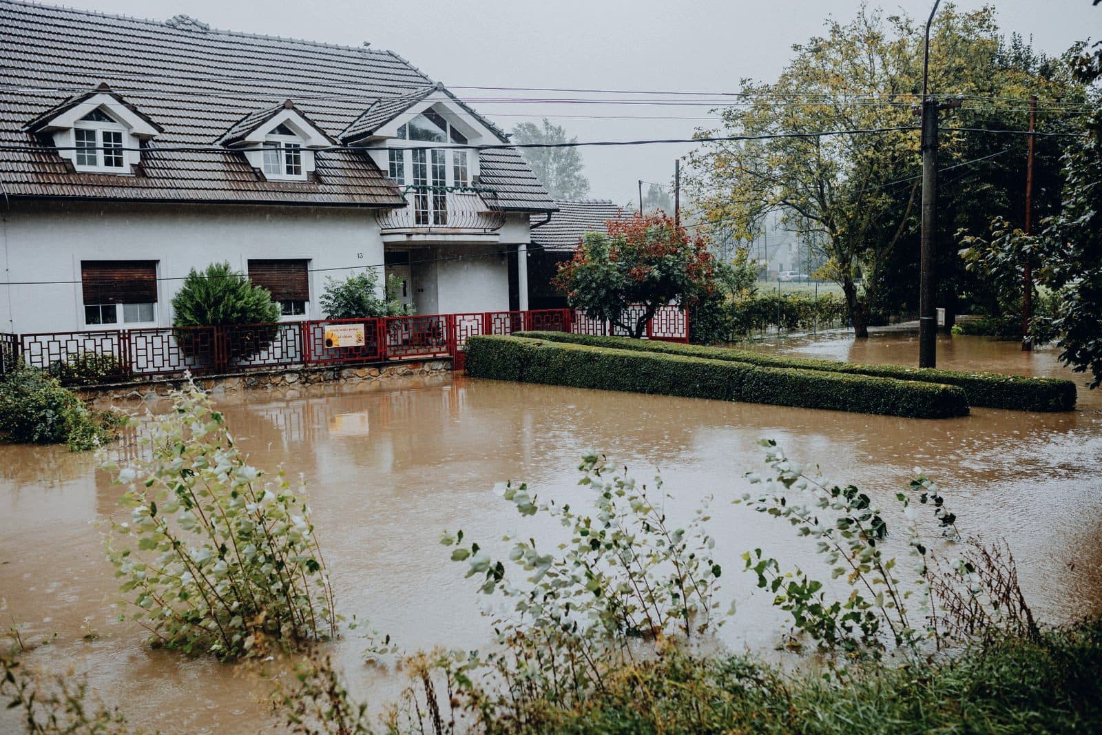 Floodwater surrounding a suburban house after heavy rain