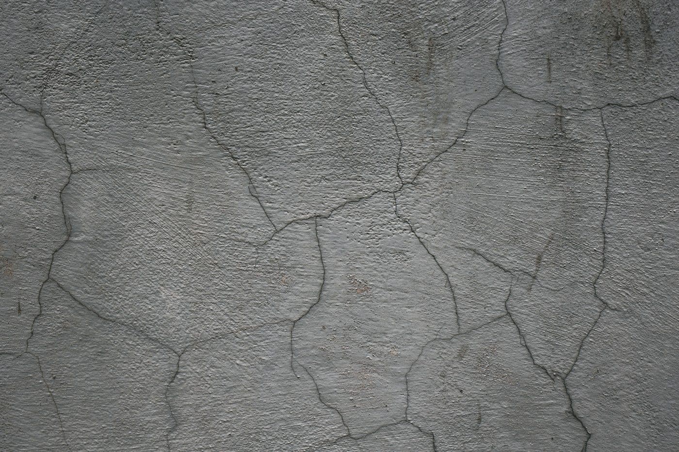 Cracking across a hard surface caused by ground movement