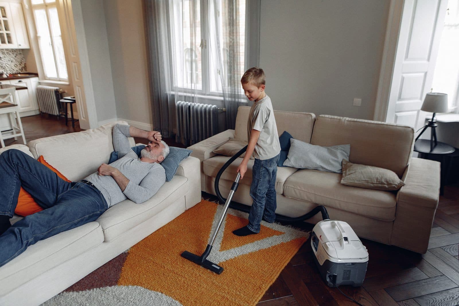 A family relaxing in a bright living room, back to normal after repairs